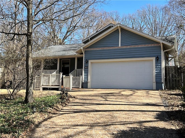 single story home with driveway, covered porch, a garage, and roof with shingles