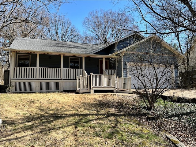 ranch-style home with covered porch, concrete driveway, a front yard, and a garage