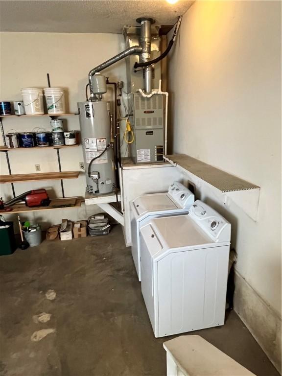 utility room with independent washer and dryer and gas water heater