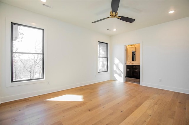 empty room with recessed lighting, light wood-style floors, visible vents, and baseboards