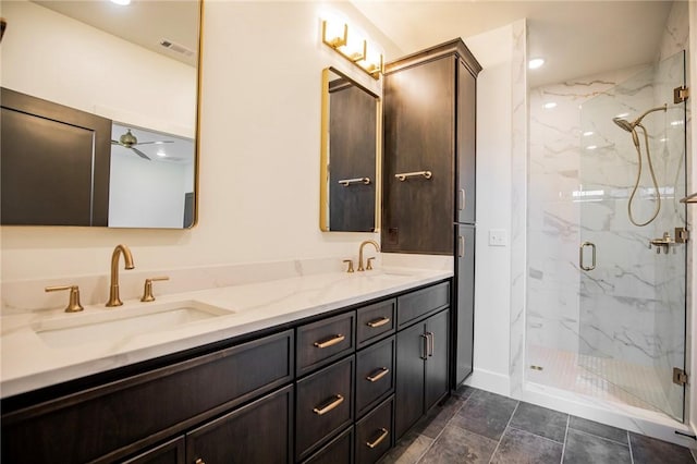 bathroom with a sink, a marble finish shower, visible vents, and double vanity