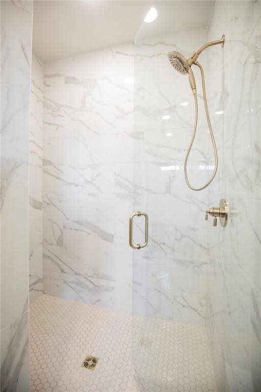 full bath with a marble finish shower