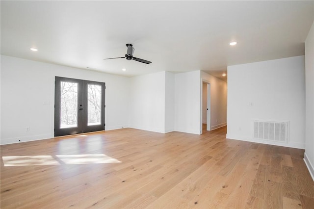 empty room with visible vents, light wood finished floors, recessed lighting, ceiling fan, and french doors