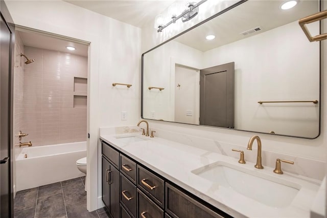 full bathroom featuring a sink, visible vents, toilet, and double vanity