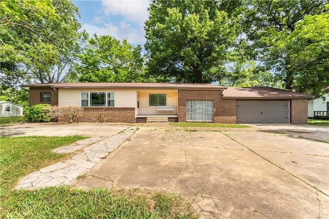 ranch-style house with a garage, driveway, and brick siding