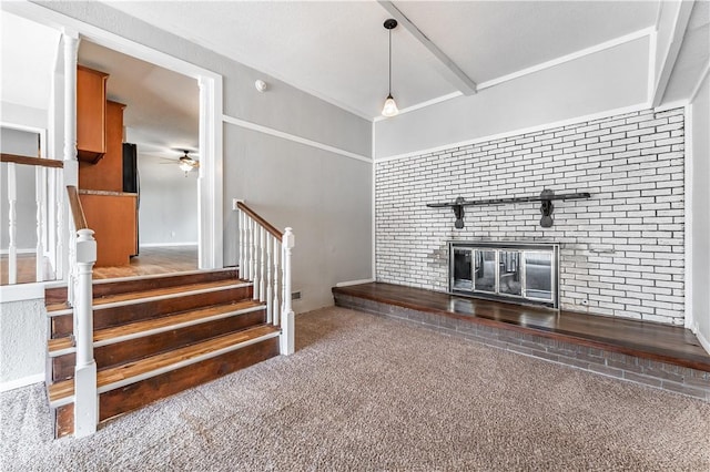 unfurnished living room featuring carpet floors, ceiling fan, a fireplace, and stairs