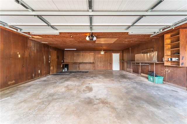 garage featuring wooden walls and a garage door opener