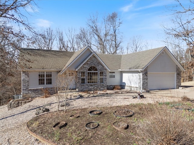 ranch-style home with concrete driveway, roof with shingles, and an attached garage