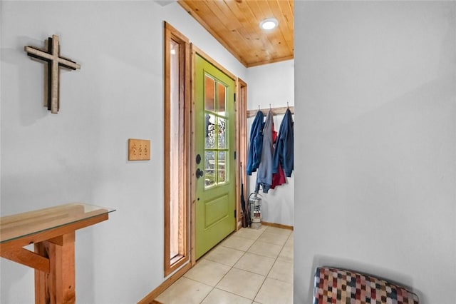 interior space featuring wooden ceiling, light tile patterned flooring, and baseboards