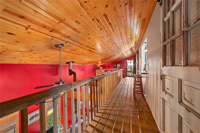 corridor featuring vaulted ceiling, wooden ceiling, and hardwood / wood-style floors