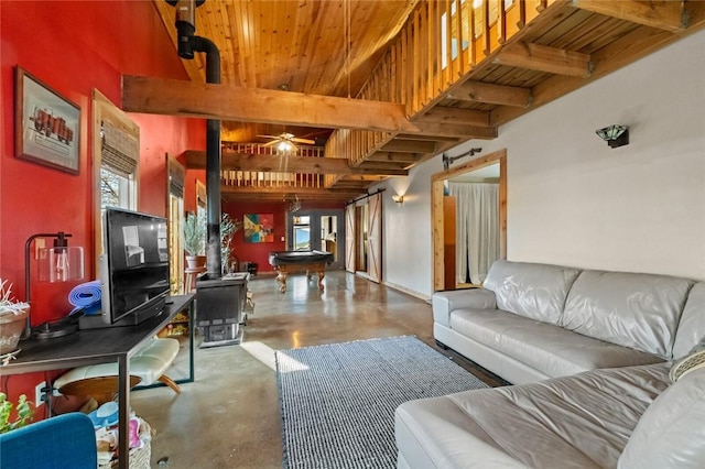 living area with beamed ceiling, finished concrete flooring, pool table, wood ceiling, and ceiling fan