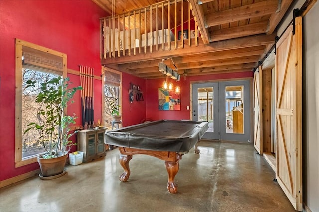 recreation room with a wealth of natural light, french doors, and concrete floors