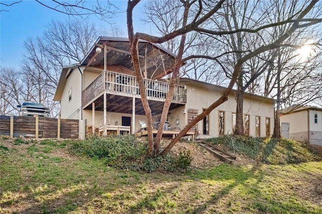 rear view of house with stairs, a deck, and fence