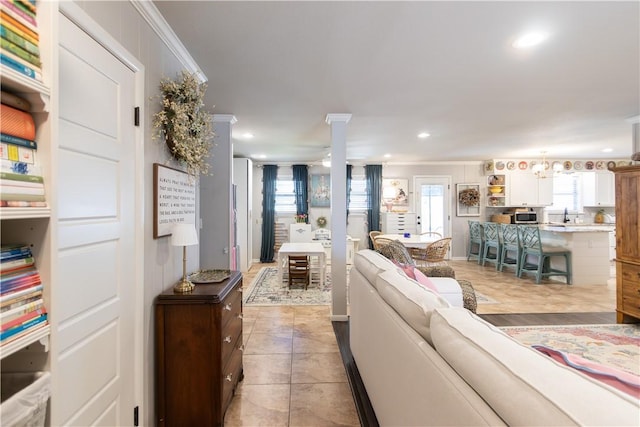 living area with light tile patterned floors, ornamental molding, recessed lighting, and ceiling fan