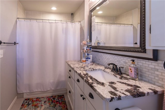 bathroom with backsplash, vanity, and a shower with curtain