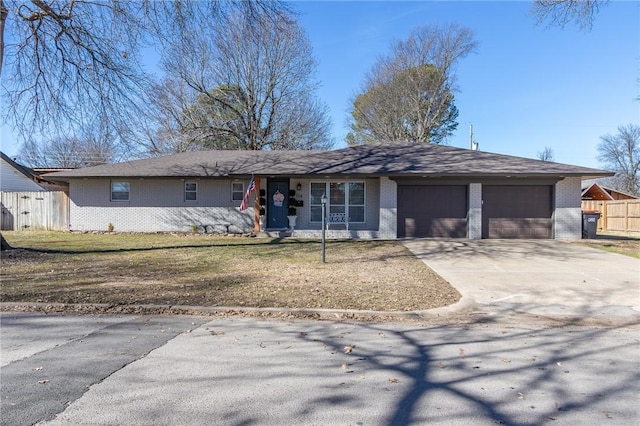 single story home featuring a garage, brick siding, concrete driveway, and fence