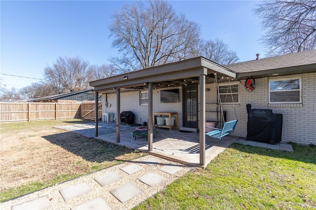 view of patio with a grill and a fenced backyard