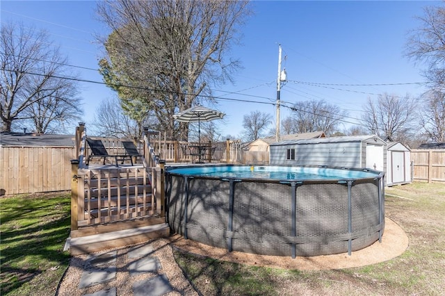 view of pool featuring an outbuilding, a shed, a fenced in pool, and a fenced backyard