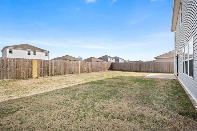 view of yard featuring a patio area and a fenced backyard