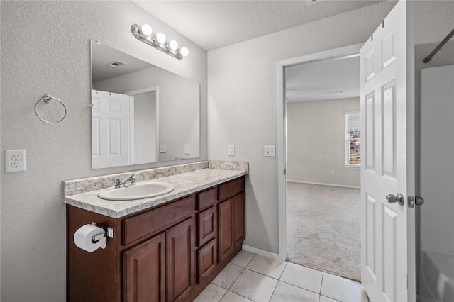 bathroom featuring visible vents, baseboards, a textured ceiling, vanity, and tile patterned floors
