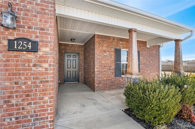 property entrance featuring brick siding