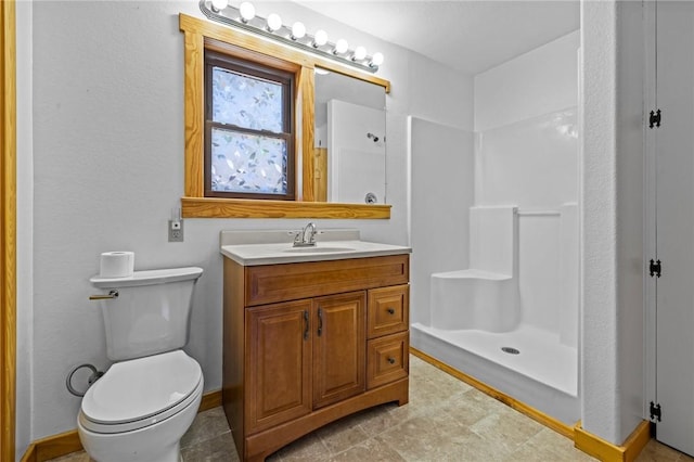 8943 Rambo Rd, Rogers, AR 72756 - bathroom with baseboards, toilet, a shower stall, and vanity