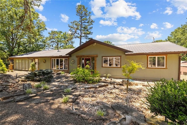 ranch-style house with metal roof