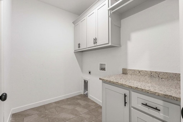 washroom with cabinet space, hookup for a washing machine, electric dryer hookup, and baseboards