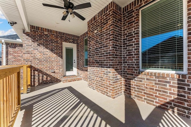 exterior space with brick siding and ceiling fan