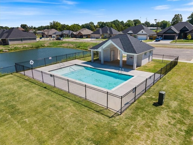 view of swimming pool with a lawn, fence, a residential view, and a fenced in pool