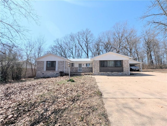 single story home with driveway and a carport