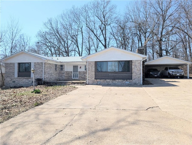 single story home with a carport, crawl space, brick siding, and driveway