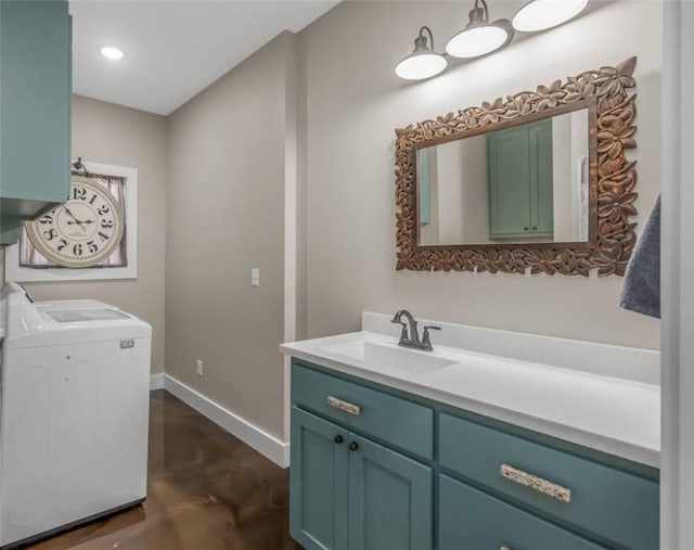 bathroom with concrete flooring, recessed lighting, vanity, baseboards, and washer and dryer