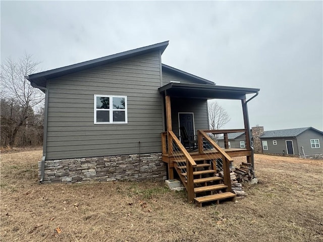 rear view of property featuring a deck