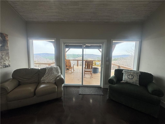 living room featuring a mountain view and finished concrete flooring