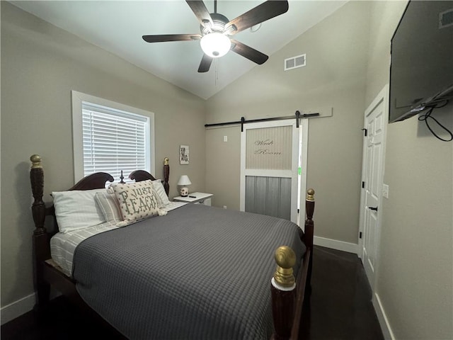 bedroom with lofted ceiling, visible vents, a barn door, ceiling fan, and baseboards