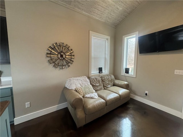 living room with lofted ceiling, wooden ceiling, finished concrete floors, and baseboards