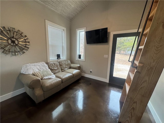 living room with vaulted ceiling and baseboards