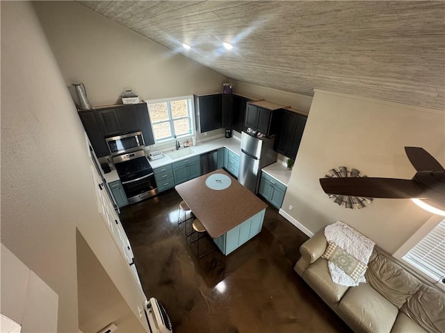 kitchen with stainless steel appliances, concrete floors, a sink, vaulted ceiling, and light countertops