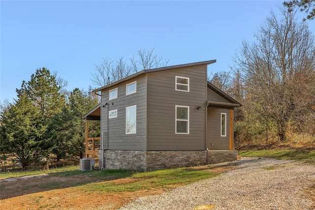 view of side of home featuring central AC