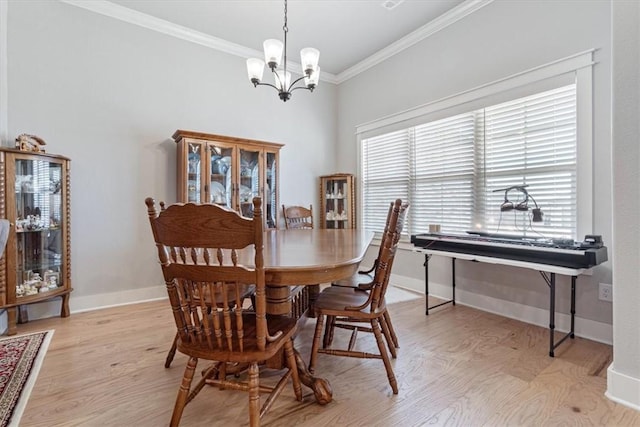 dining space featuring light wood finished floors, baseboards, ornamental molding, and a wealth of natural light