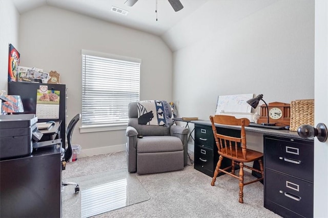 office area featuring lofted ceiling, carpet, visible vents, and a ceiling fan