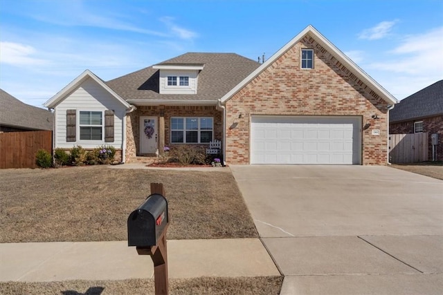 view of front facade with a garage, fence, concrete driveway, and brick siding