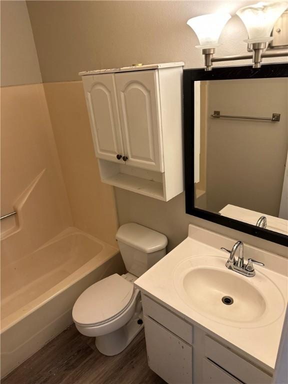 full bathroom with vanity, toilet, and wood finished floors