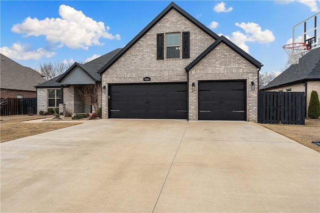 french provincial home with an attached garage, fence, concrete driveway, and brick siding