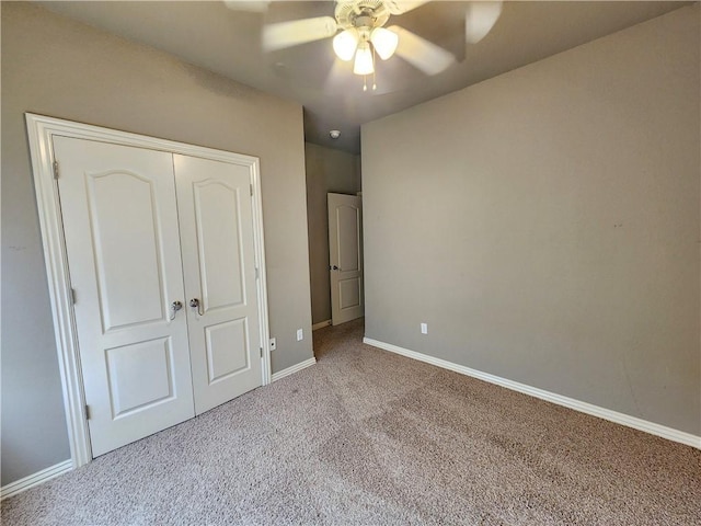 unfurnished bedroom with baseboards, carpet, a ceiling fan, and a closet