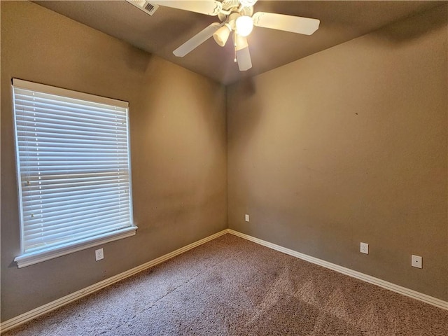 unfurnished room featuring ceiling fan, visible vents, baseboards, and carpet flooring