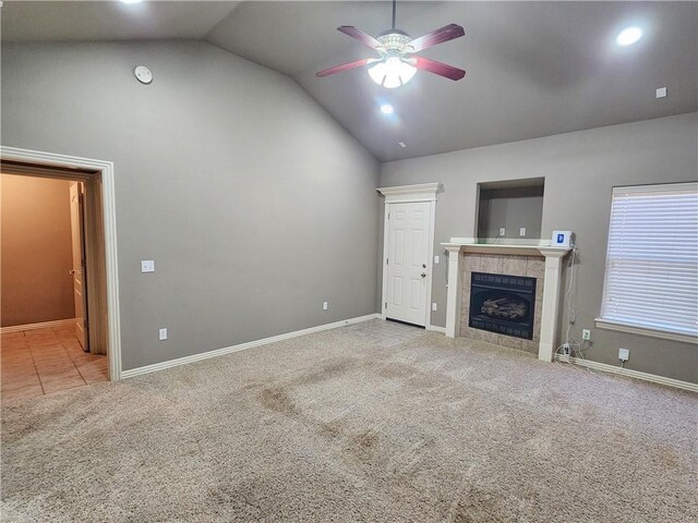 unfurnished living room featuring baseboards, a tile fireplace, ceiling fan, carpet flooring, and high vaulted ceiling