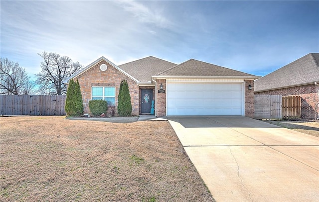 ranch-style home with concrete driveway, brick siding, fence, and an attached garage