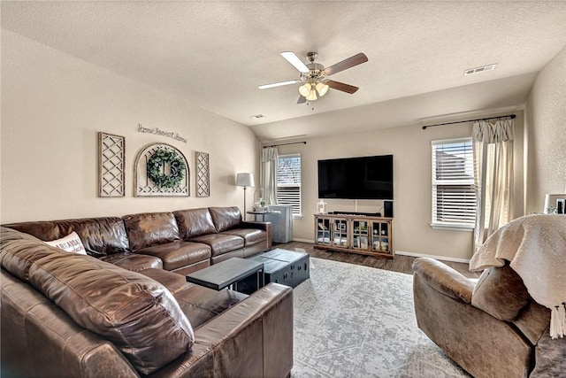 living room with visible vents, ceiling fan, a textured ceiling, and wood finished floors